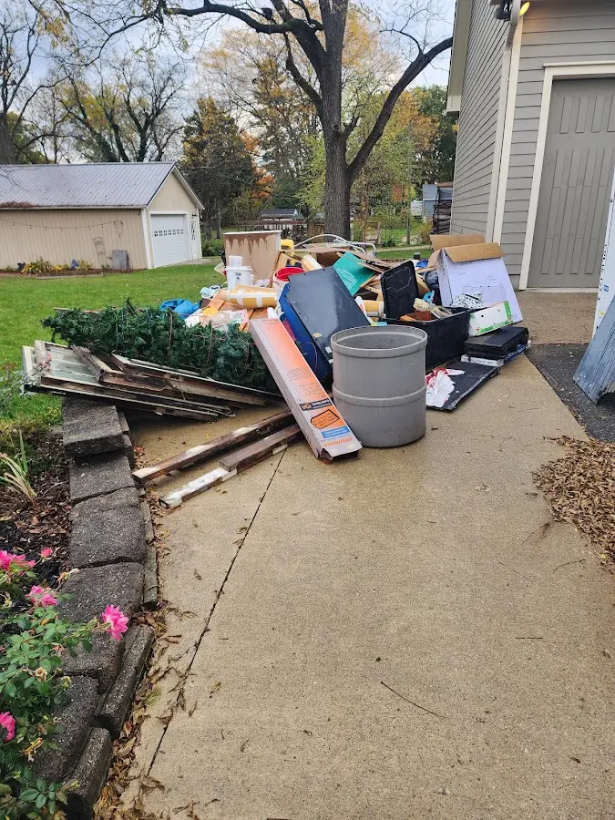 Dumpster being loaded with debris for Commercial Dumpster Rental in Muskogee